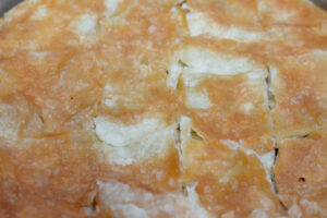 Raqaq pastry bake, golden-brown layers, showcasing traditional Egyptian Rogan dish preparation.