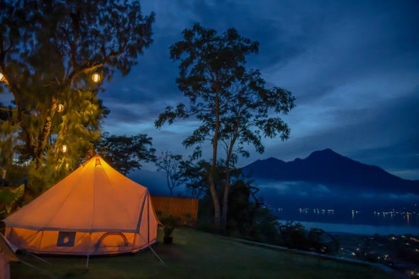 Night camping in mountains near lake