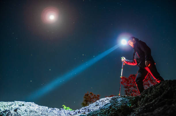 man hiking in night wearing headlamp