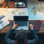 a digital nomad sitting at a sleek, modern desk with a laptop and passport, surrounded by travel photos and a world map.