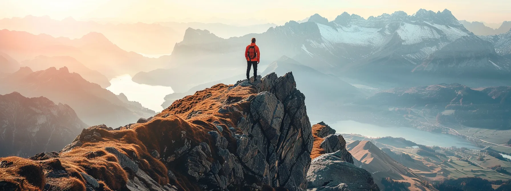 a lone traveler standing on a mountain peak, surrounded by vast, breathtaking landscapes, drawing inspiration for future creative projects.