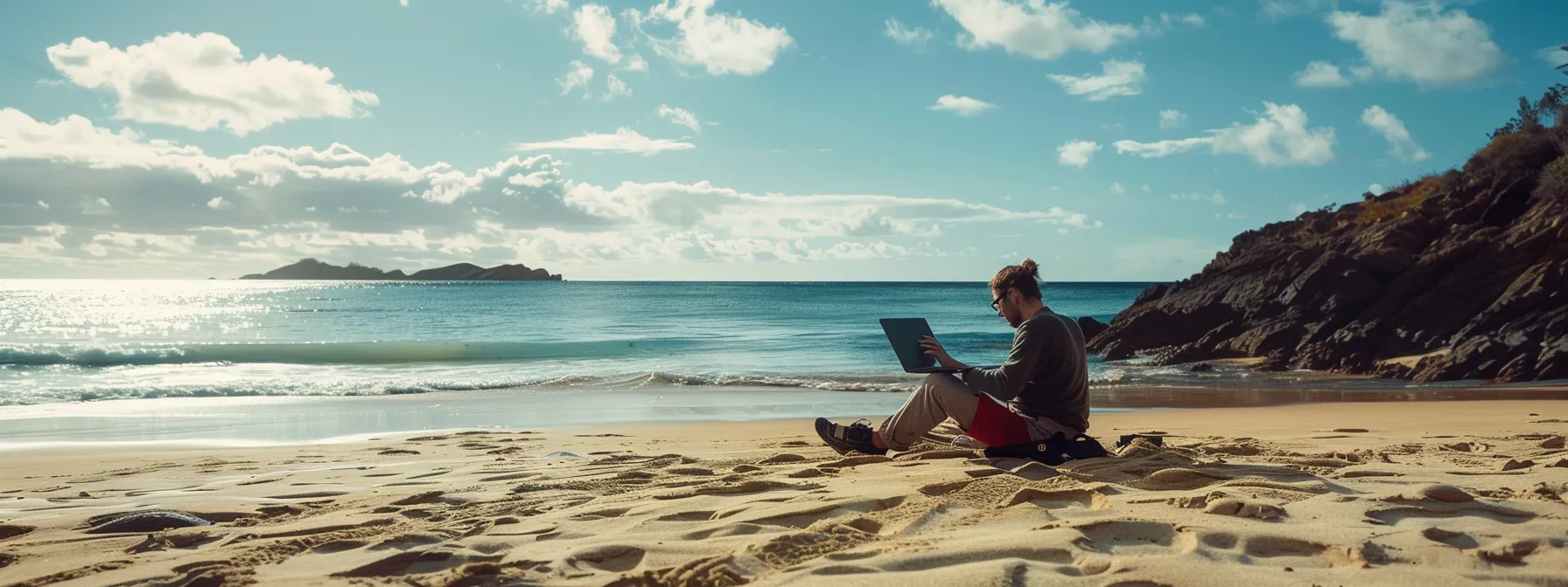 a laptop-clad individual working on a sandy beach with a stunning ocean view, showcasing the freedom and flexibility of a digital nomad visa.