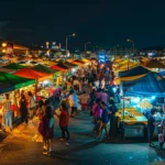 crowded night market with colorful food stalls in penang.