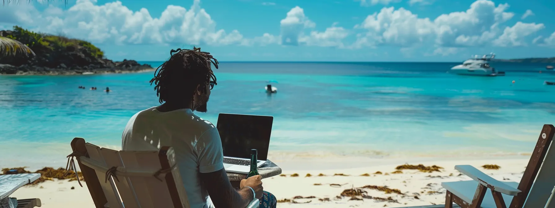 a digital nomad working on a laptop with a stunning backdrop of the caribbean beach and clear blue waters.