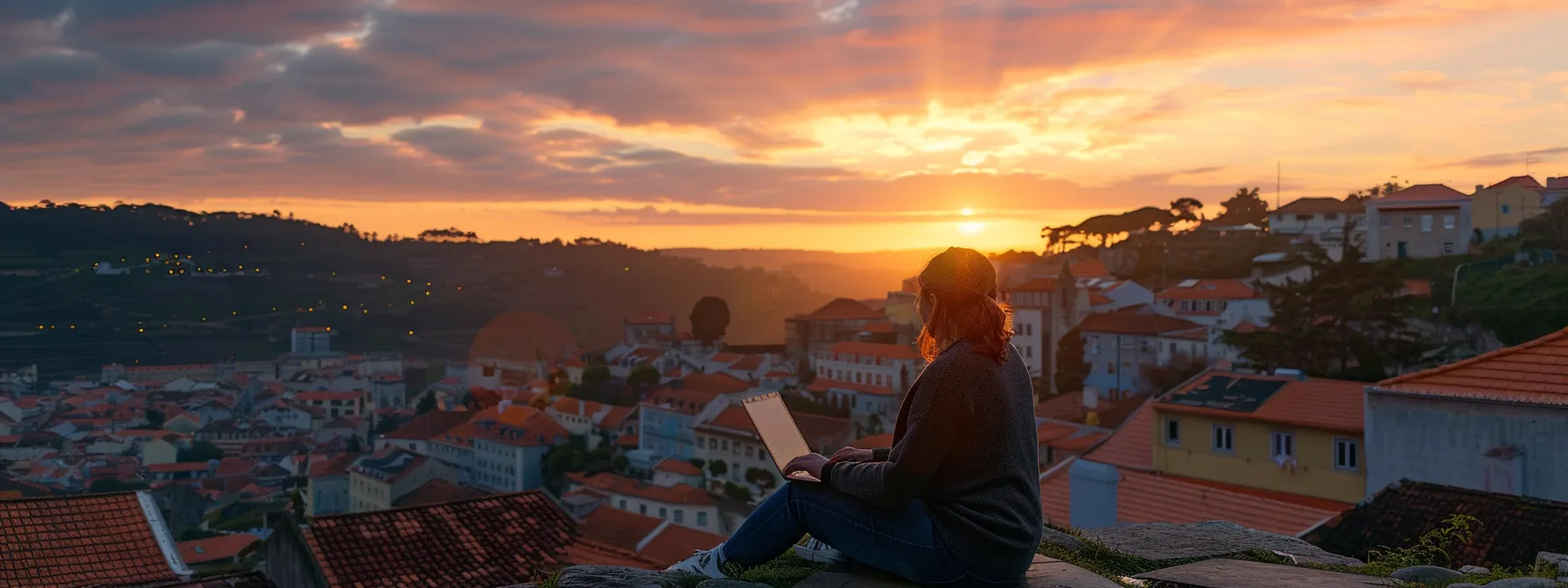 a person working on a laptop while enjoying the scenic view of portugal's landscape.