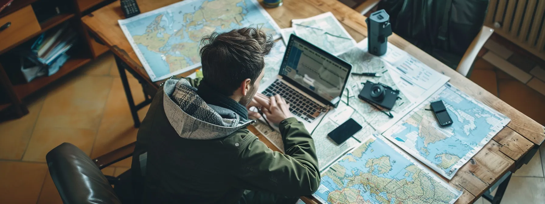 a traveler sitting at a sleek, modern desk surrounded by maps and a laptop, comparing health insurance coverage details and plan benefits.