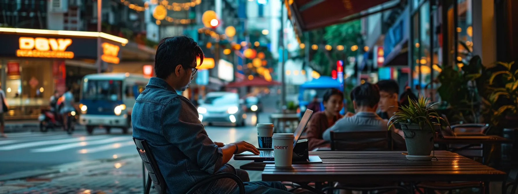 a traveler sitting at a vibrant outdoor cafe, surrounded by locals, enjoying a cup of coffee and working on a laptop with a diverse cityscape in the background.