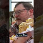 ExploreTraveler video thumbnail for a Ramly burger wrapped in egg in Kuala Lumpur, Malaysia.